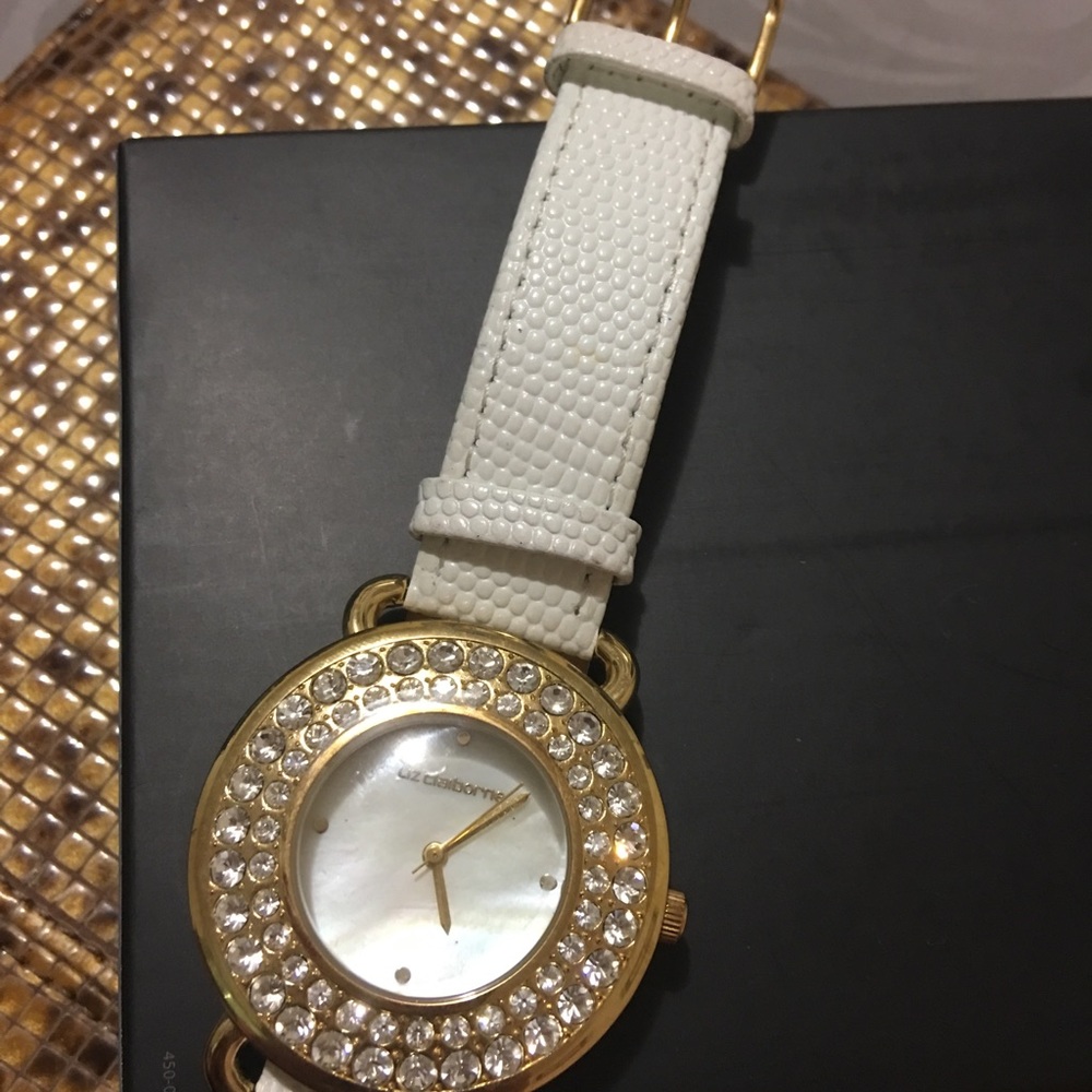Watch with white belt Gold face.